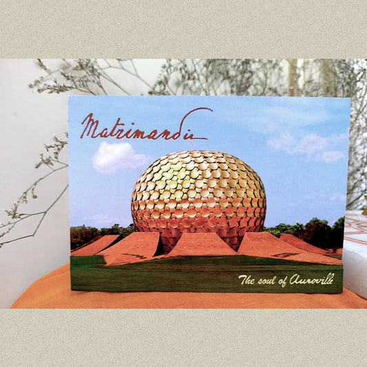 A 3D paper craft photo magnet featuring the Matrimandir, a globe-patterned structure, with the text 'Matrimandir - The Soul of Auroville' at the bottom.