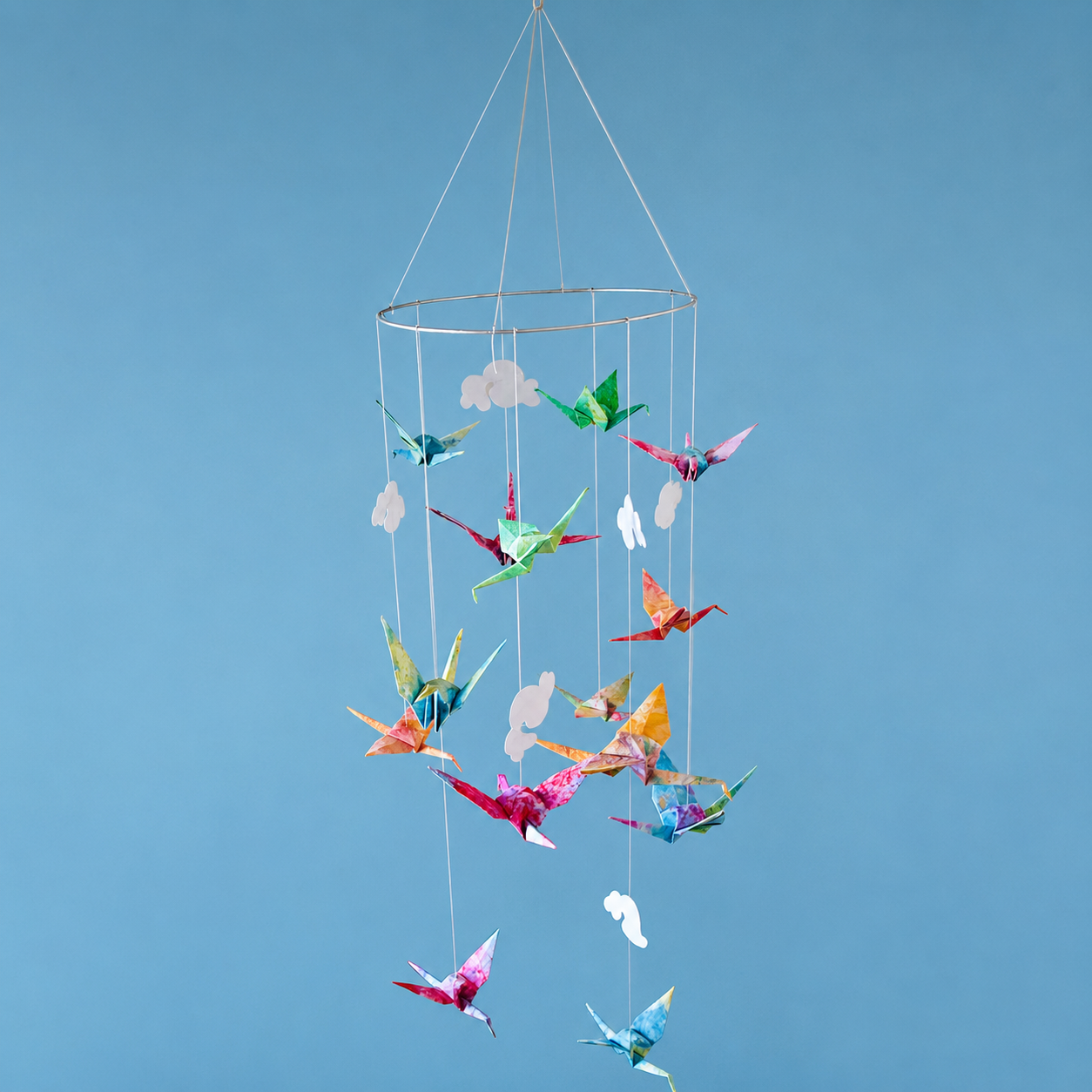 ceiling suspended kid's toy on a thin circular frame of bright origami cranes