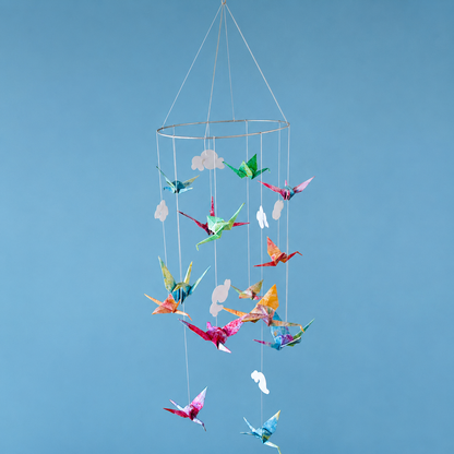 ceiling suspended kid's toy on a thin circular frame of bright origami cranes