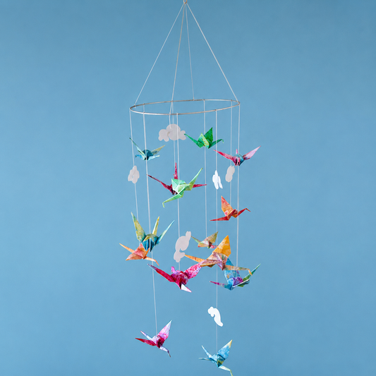 ceiling suspended kid's toy on a thin circular frame of bright origami cranes