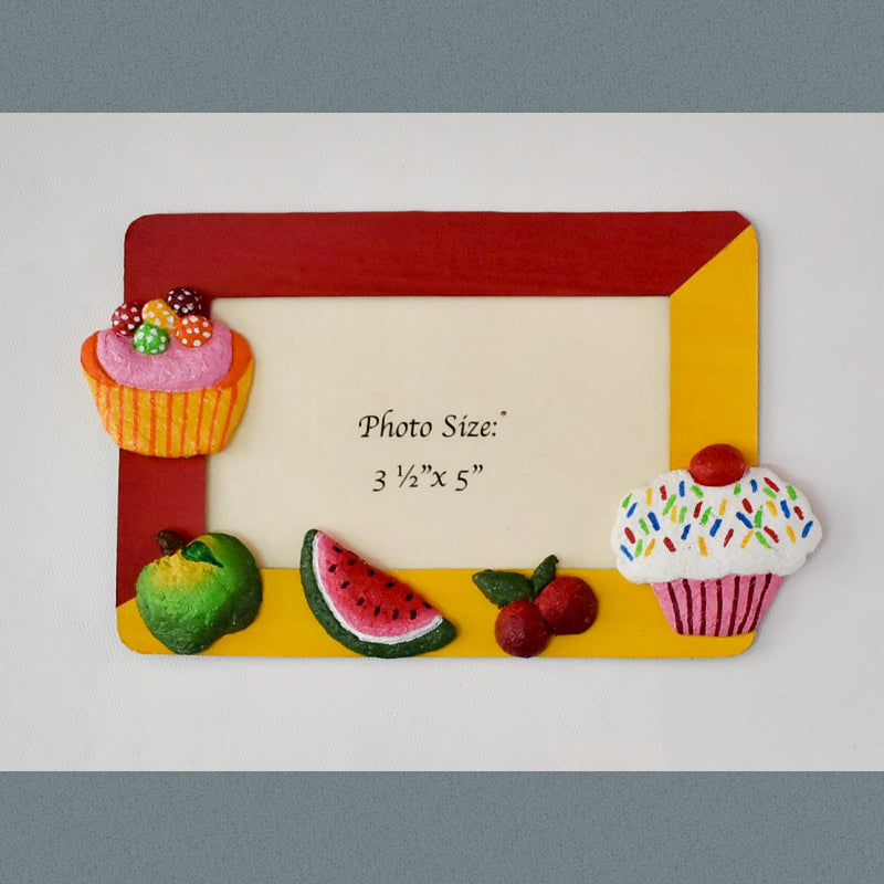 A rectangular Magnetic Photo frame exquisitely handmade with paper pulp designs – Cupcake, ice cream, apple, cherries and a piece of watermelon.