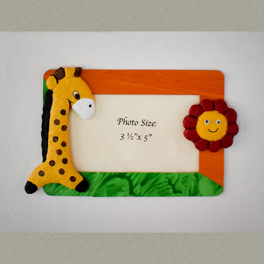 A rectangular Magnetic Photo frame exquisitely  handmade with paper pulp  designs - Giraffe and a Maroon flower with Yellow Center.