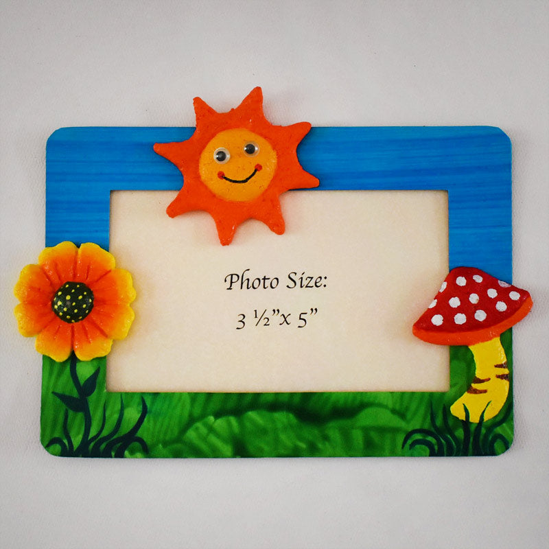 A rectangular Magnetic Photo frame exquisitely  handmade with paper pulp  designs - Bright Yellow Flower, Mushroom with white dots on red & a smiling Sun in Orange and Yellow.