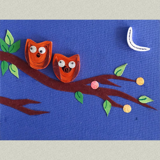 A rectangular Fridge Magnet handcrafted with a pair of quilled Owls perched on a paper cut-out tree branch on a moonlit night.